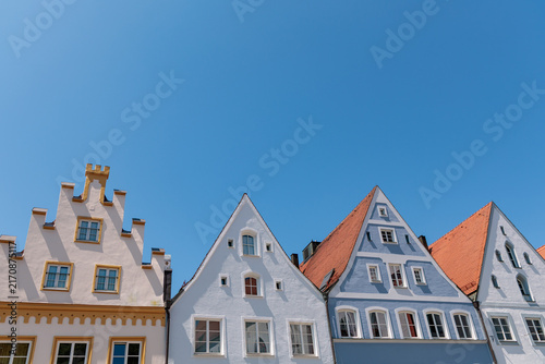 Row of historic gabled house facades under clear blue sky in Landsberg am Lech, traditional Bavarian architecture concept