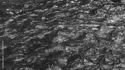 фотографія Monochrome close-up of gently moving freshwater with overlapping ripples and subtle reflections, creating a calm natural water texture
