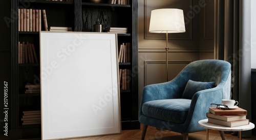 Blank white canvas leaning against a dark bookshelf in a cozy living room with a blue velvet armchair and a floor lamp.