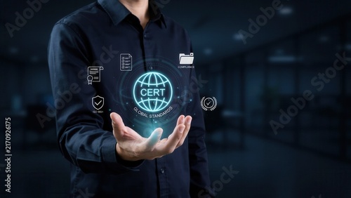 Professional businessman holding glowing holographic icons representing global certification and compliance standards inside a modern dark corporate office space environment today