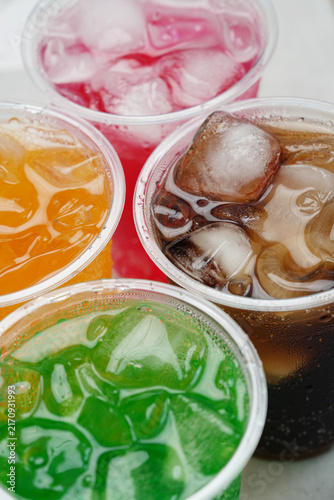 Soft drinks and fruit juice mixed with soda high in sugar have a negative effect on physical health. vertical.	