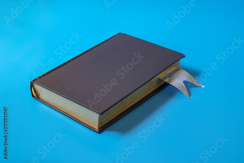 A book with bookmarks on a light background.