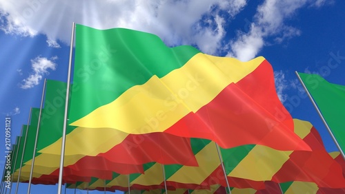 Multiple Republic of Congo flags waving on blue sky