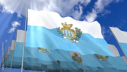 Multiple San Marino flags waving on blue sky