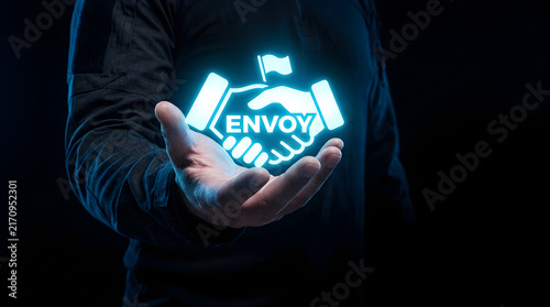 Person holding a glowing digital handshake icon with envoy text