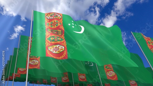 Multiple Turkmenistan flags waving on blue sky
