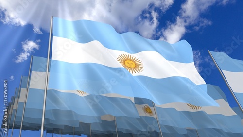 Multiple Argentina flags waving on blue sky