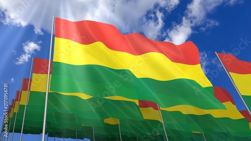 Multiple Bolivia flags waving on blue sky