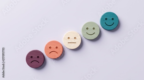 Wooden emotion tokens in a row showing range of feelings