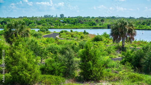 Multipurpose trail winds through a nature preserve with a tidal lagoon, part of a transformational project for habitat restoration, research, and recreation, along the Gulf Coast of southwest Florida