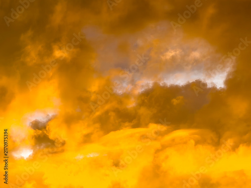 Cloudscape at sunset, with vivid orange, during peak Saharan dust season, summer in southwest Florida. Motifs of transition, atmospheric conditions, and the subtropics.