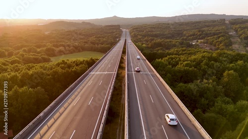 Aerial view of highway viaduct traffic at sunset