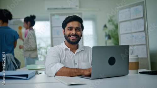 portrait of Indian businessman happy and smile with pride, about us or confident compliance agent in a modern office setting.smile and professional in company for career ambition as policy officer