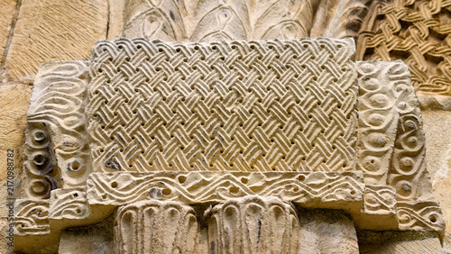 Фотография Intricate stone carving of interwoven geometric and wave motifs on the divrigi g