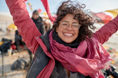 Joyful outdoor adventure and freedom happy young woman with arms raised smiling in nature