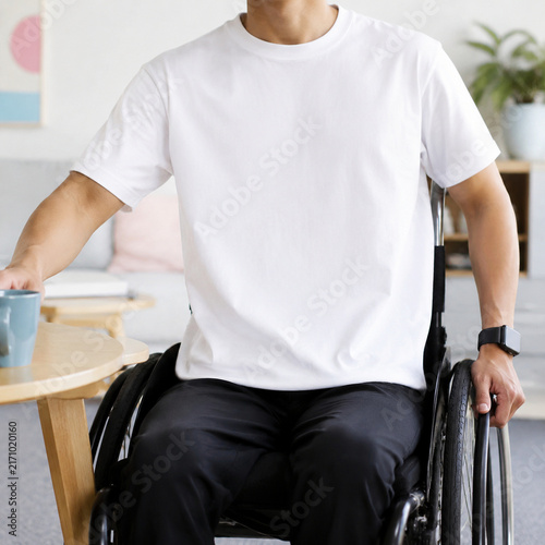 A person in a wheelchair enjoys a peaceful moment sipping coffee at home, embracing a positive lifestyle.