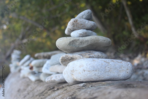 Serene Stacked Zen Stones Balancing Cairn in Forest Nature Background.

