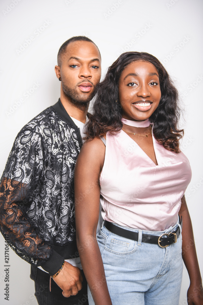 Obraz premium young adult american man and sister standing on white background with fashion clothes