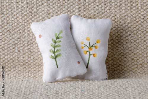 White pillows with little plants on sofa