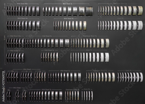 Photography Industrial metal cutting test samples arranged by material, thickness and laser
