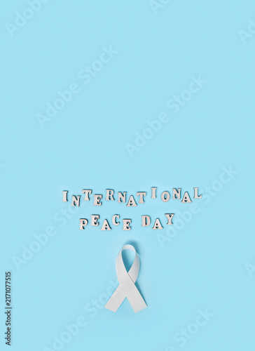 Photography International Day of Peace awareness concept with white symbolic ribbon, represe
