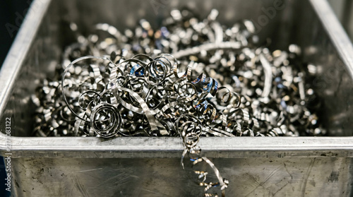 Industrial Metal Shavings and Steel Swarf Spirals in a Metal Bin