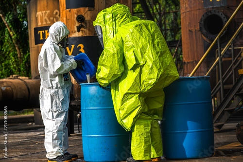 Cuadro en lienzo Male firefighters wearing full chemical protective suit, hazmat gear, and selfbr