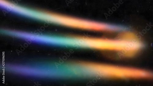 Abstract streaks of rainbow light against a black background