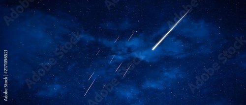 Bright shooting star in a dark blue starry night sky