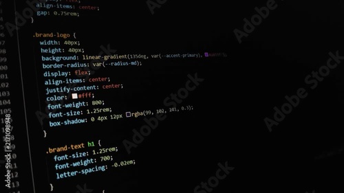 Computer source code scrolling on a dark screen editor