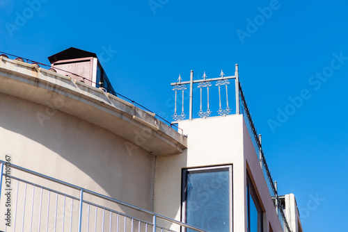Low‑angle partial close‑up of iron railings on building roof