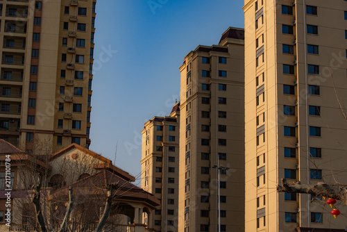 High‑rise residential building cluster in community under clear blue sky