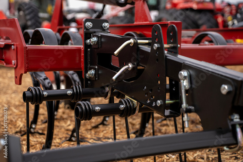 Quadro su tela Adjustable metal frame bracket with pins, bolts, and spring tines on modern agricultural soil cultivator machine