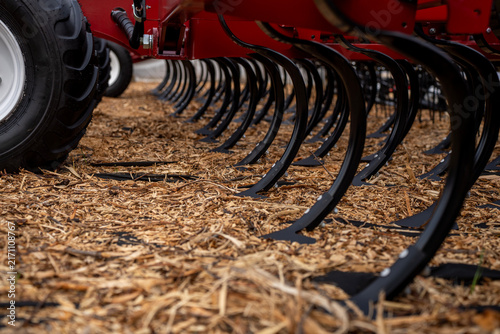Принти на полотні Row of curved steel tines on agricultural soil cultivator machine prepared for field tillage and weed control