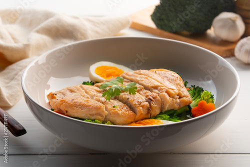 Healthy Diet High Protein Low Fat,Grilled Chicken breast with boiled egg and broccoli in white plate.weight loss menu.