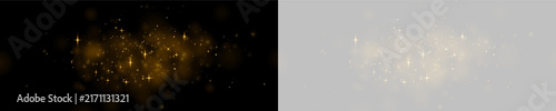 Fotografie A cluster of bright golden sparkles floats on a black background