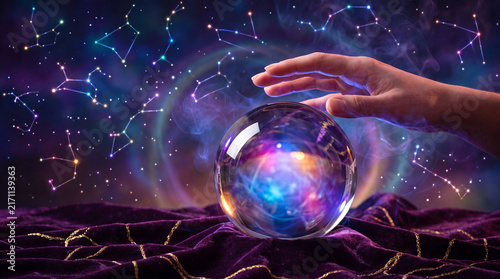 Crystal ball reading with hand and constellation light