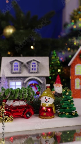 A funny Santa Claus darts past a Christmas village