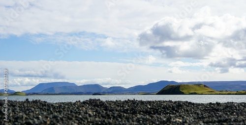 Картината върху платно Icelandic Lake with Volcanic Mountains and Black Lava Rocks