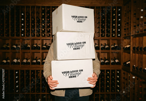 Person Carrying Cardboard Wine Boxes on Storage Branding Mockup