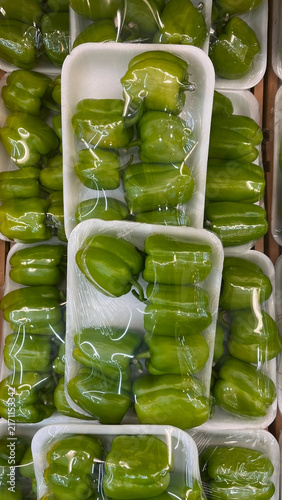 Quadro su tela Fresh, meaty green bell peppers displayed on foam trays wrapped in plastic