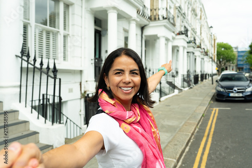 Canvas Print Woman tourist holding hand pointing enjoying London Notting Hill street vacation