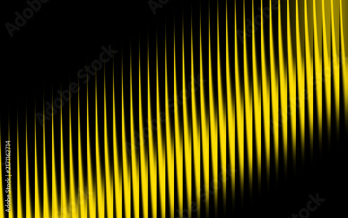 Abstract yellow light streaks on black background, vertical glowing lines pattern