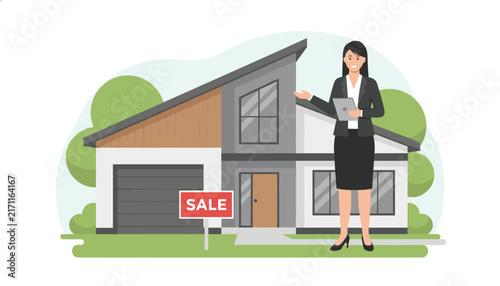 Professional female real estate agent in a dark business suit presenting a modern house for sale with a red sign.