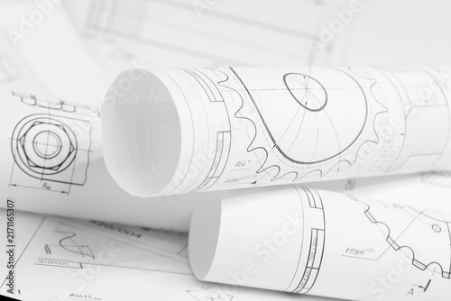 paper engineering drawings of industrial parts and mechanisms