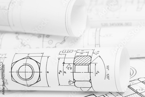 paper engineering drawings of industrial parts and mechanisms