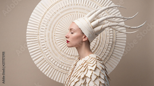 Elegant side-profile portrait of a futuristic woman wearing an intricate circular geometric headdress, blending fashion, fantasy, beauty, and contemporary artistic design.