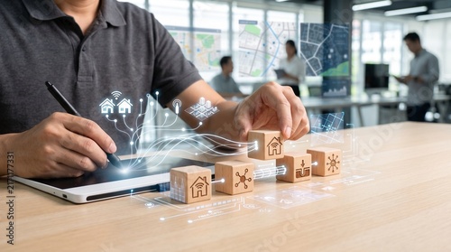 Architect planning smart home development with digital holographic house icons on blocks