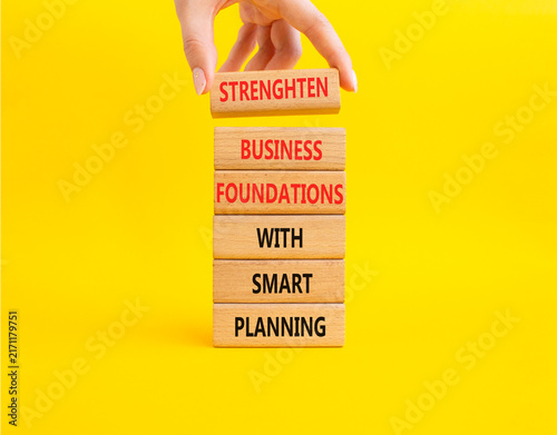 фотографія .Concept words strengthen business foundations with smart planning on wooden blo