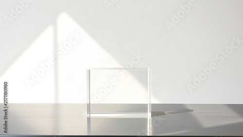 Sunbeam passing through clear acrylic block onto white wall, light transmittance concept